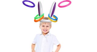 child on a white background with inflatable bunny ears on and hoopla rings