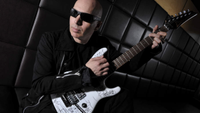 Joe Satriani posing with a guitar