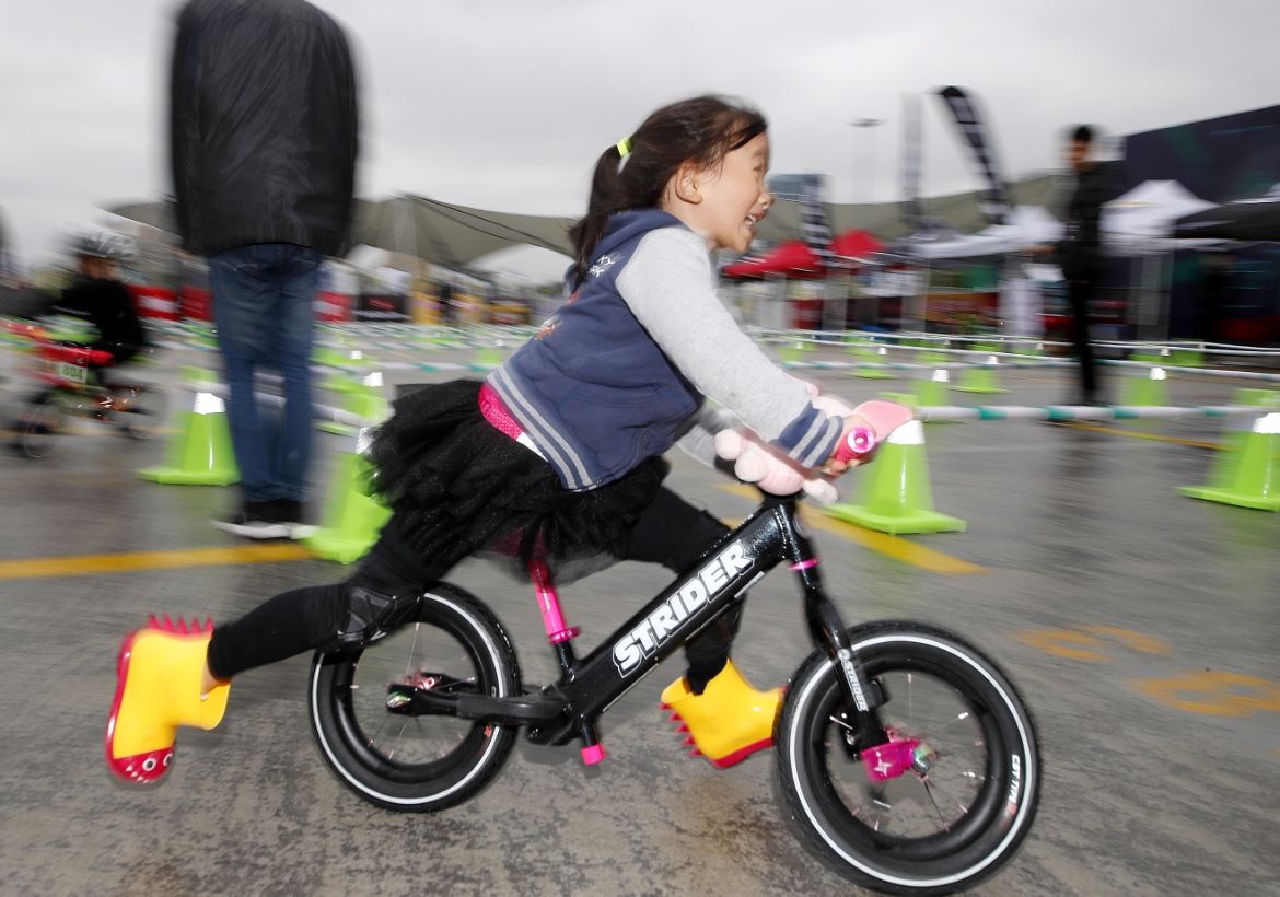 A child races her bike