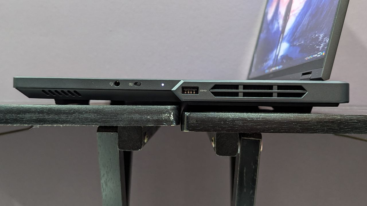 Lenovo Legion Pro 5i open on a black table, highlighting the ports on the right, including one USB Type-A, a headphone jack, a webcam killswitch.