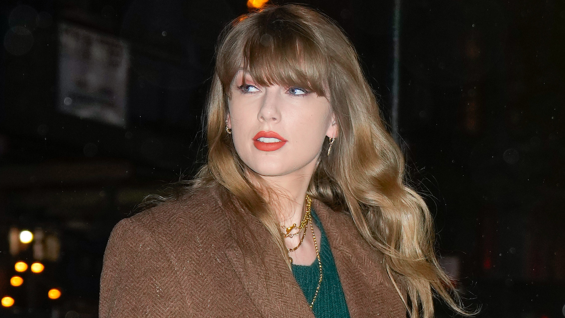 Taylor Swift posed with a fan in an anti-Showgirl plaid mini skirt