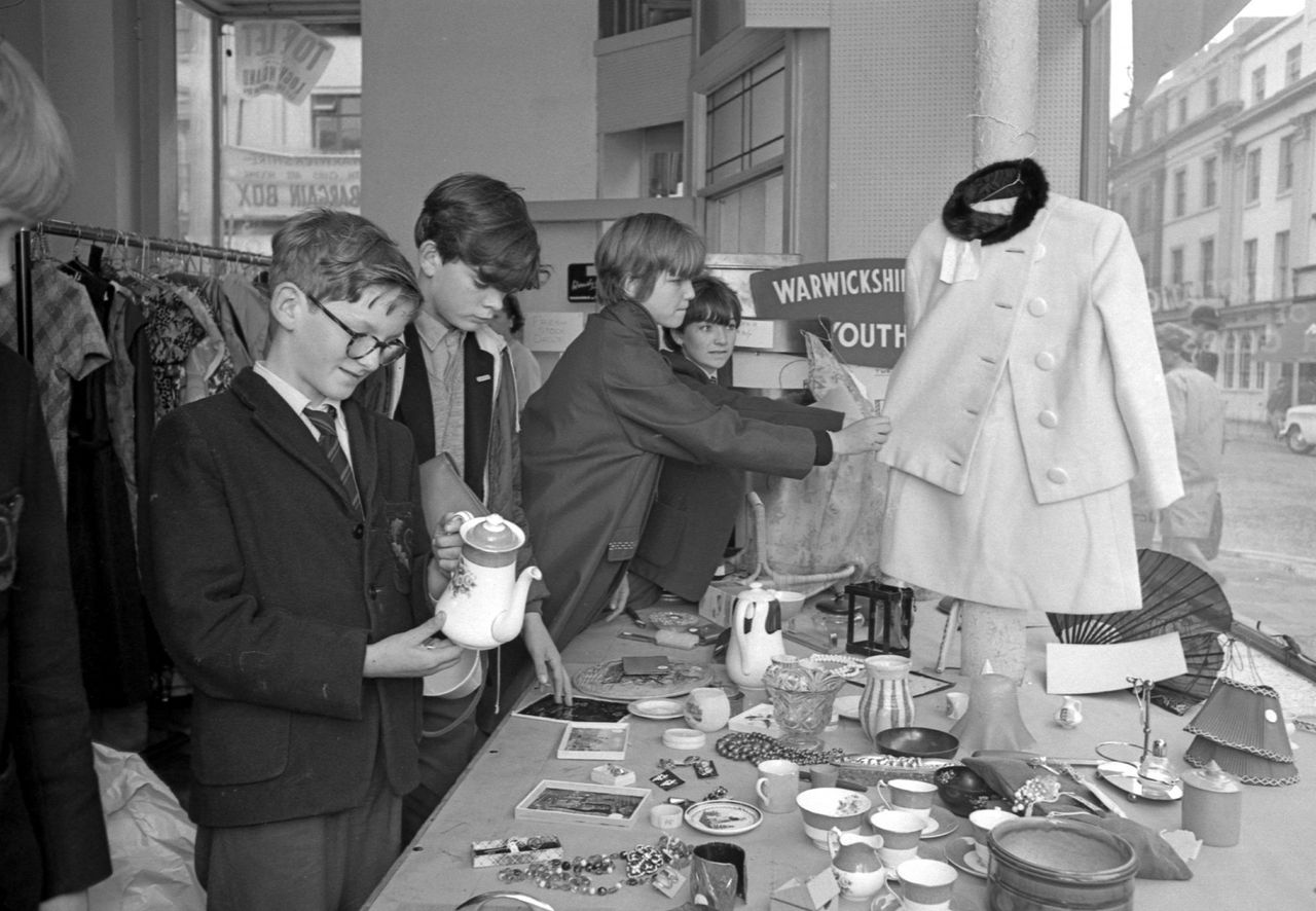 Bargain hunters descend on a Leamington charity shop in 1966 to raise a small fortune for local youth clubs. The &#039;Bargain Box&#039; in Bath Street sold clothes, toys and books donated to Warwickshire Association of Youth Clubs by well-wishers. Shoppers queued outside the shop before it opened and the first 6 hours saw £230 go through the tills. The shop was opened for a week and eventually went on to make around £1,400 for the organisation which was expanding at the time to take on more full-time officers. (Photo by Coventry Telegraph Archive/Mirrorpix via Getty Images)