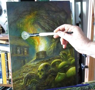 An artist adding to a painting of a house with a paintbrush
