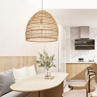 A rattan domed light fixture hanging above a dining table