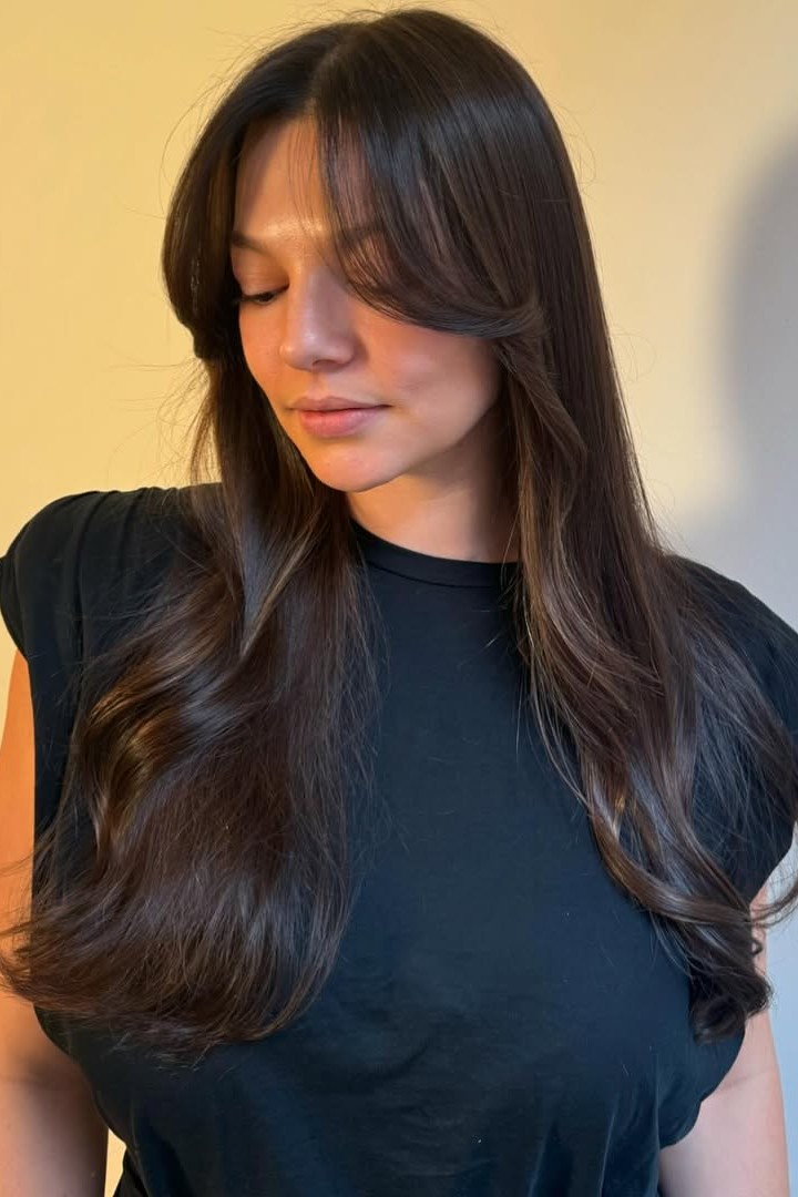 A model with their hair cut in long layers.