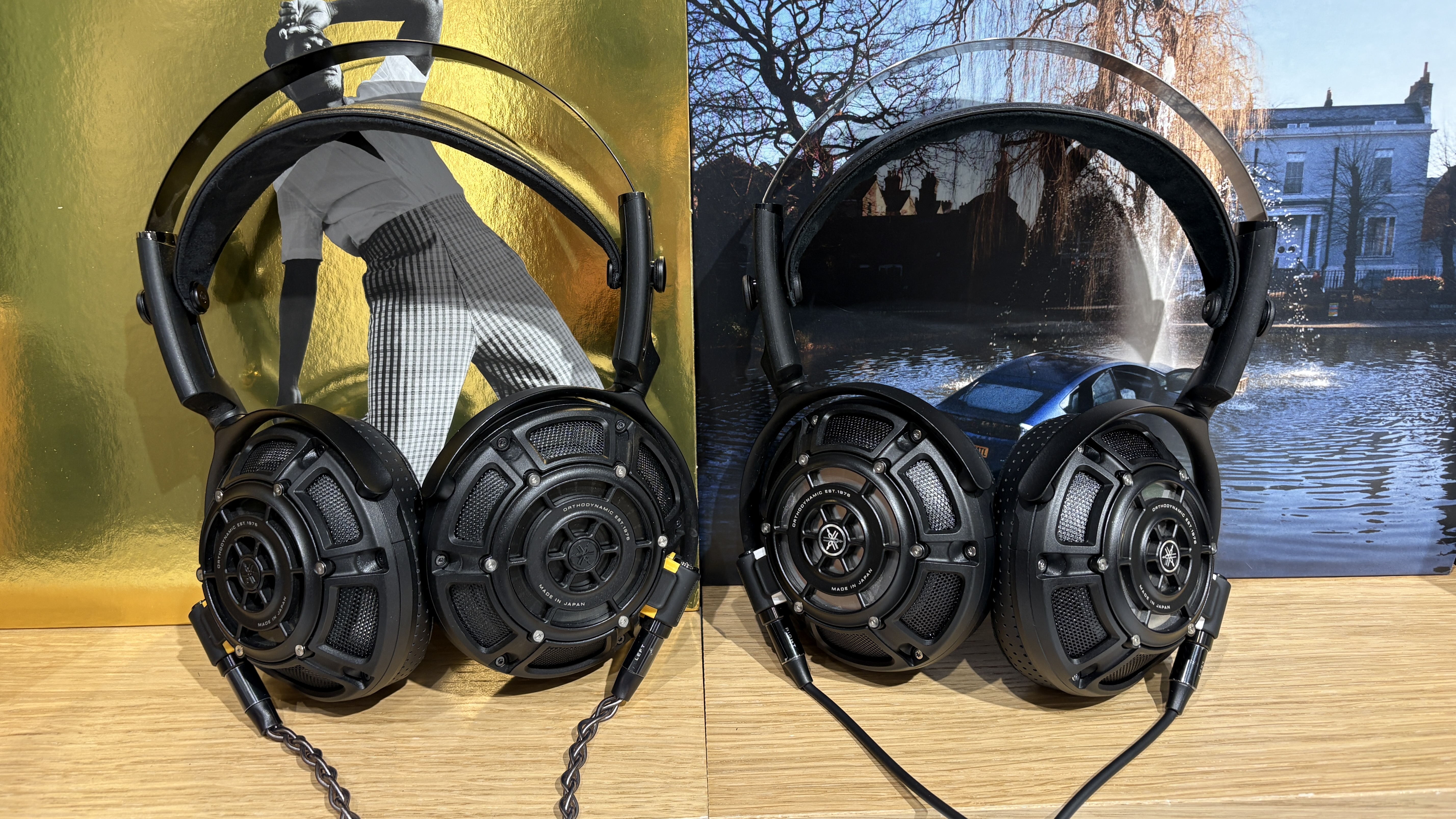 Yamaha YH-5000SE and YH-4000 headphones side-by-side on a desk with vinyl records in background