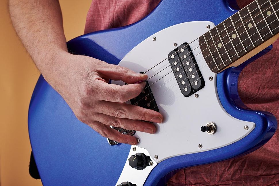 How to hold a guitar and a guitar pick Guitar World