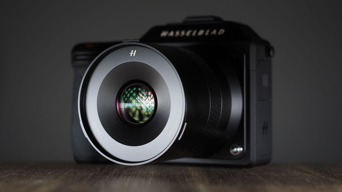 Hasselblad XCD 75P lens on a Hasselblad X2D camera, on a wooden surface against a dark background