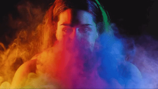 Ai created video. Woman surrounded by vibrant colored smoke