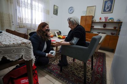 Holocaust survivor Miriam Linia receives assistance in Haifa.