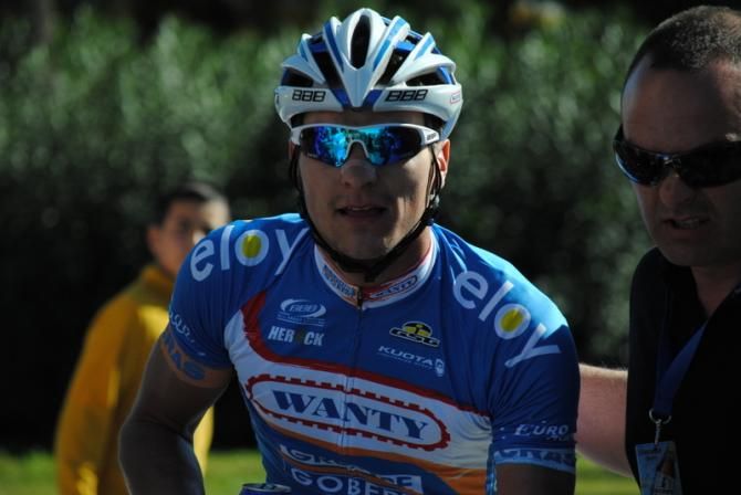 Roy Jans (Wanty), guided to the podium by a member of Vuelta a Andaluc&Atilde;&shy;a staff.