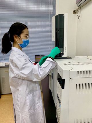 Study lead researcher Meng Ren uses a technique known as gas chromatography mass spectrometry at a lab in Beijing to analyze the plant samples found in the ancient burials.