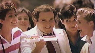 Jason Alexander holds a McDLT in front of a crowd for McDonalds.