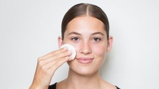 model removes makeup with a wipe
