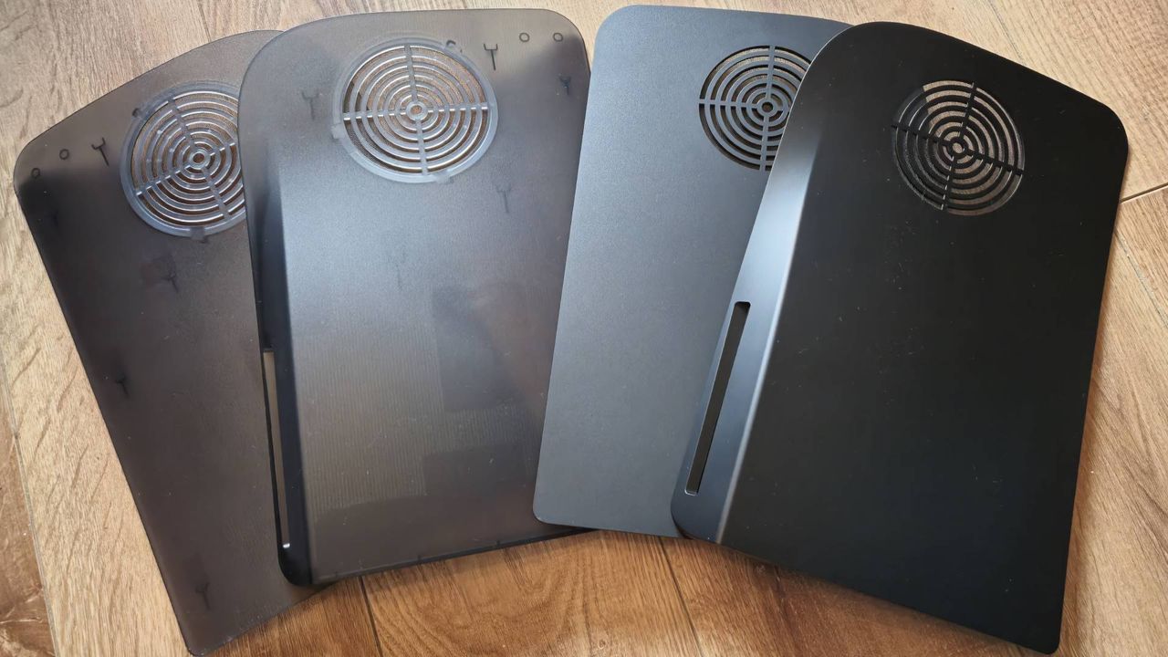 Photos of the 'Smoke Black' and Matte Black PS5 Darkplate console covers.