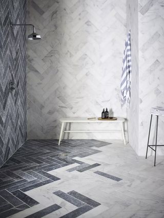 Herringbone tiles in shower by Mandarin Stone