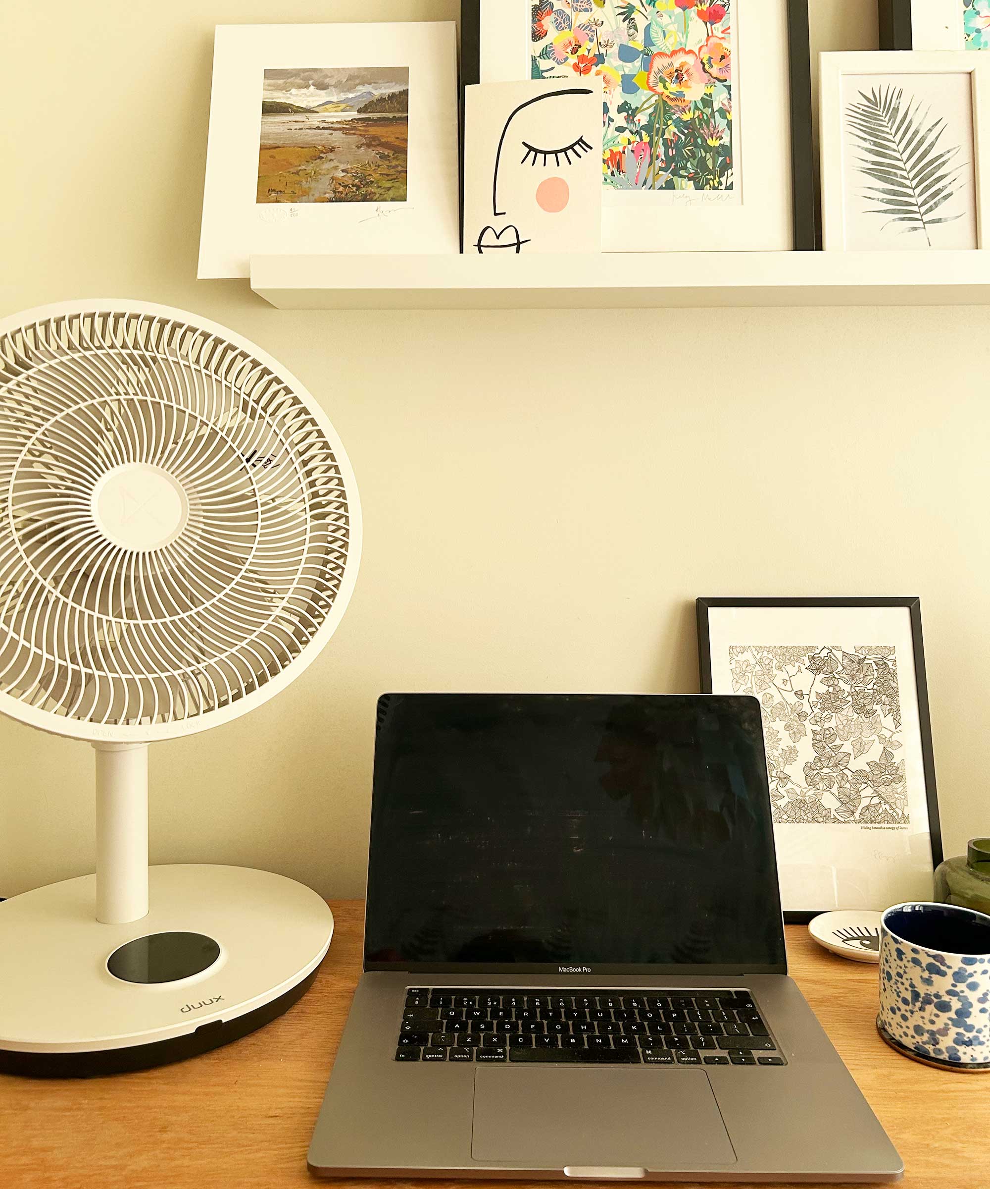 Duux Whisper Flex 2 fan used as a desk fan next to a laptop on a wooden desk