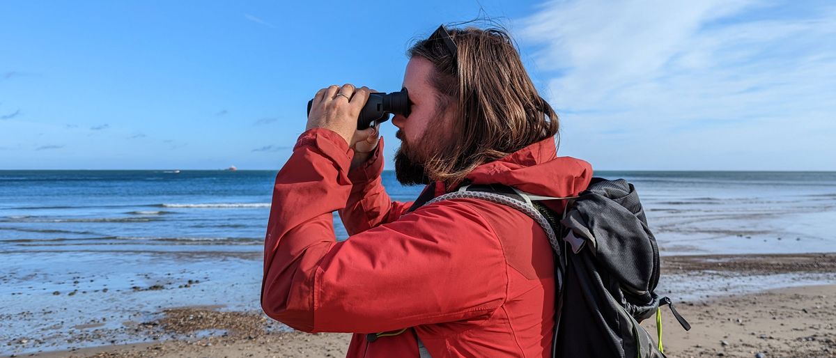 Author using the pair of binoculars