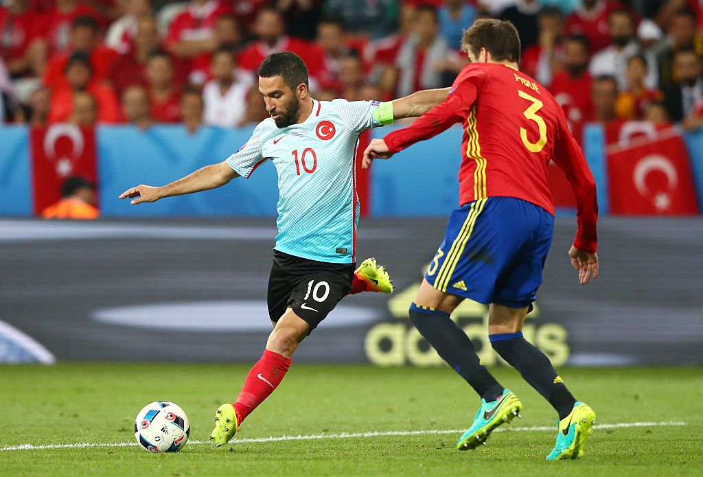 Turkey&amp;#039;s Arda Turan dribbles past Spain&amp;#039;s Gerard Pique during the UEFA Euro 2016.