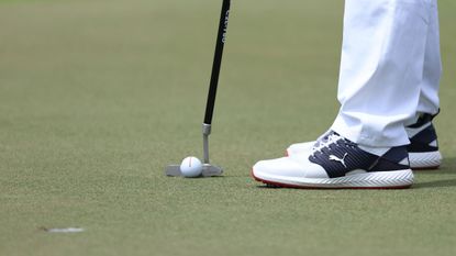 Close up of a putter and golf ball