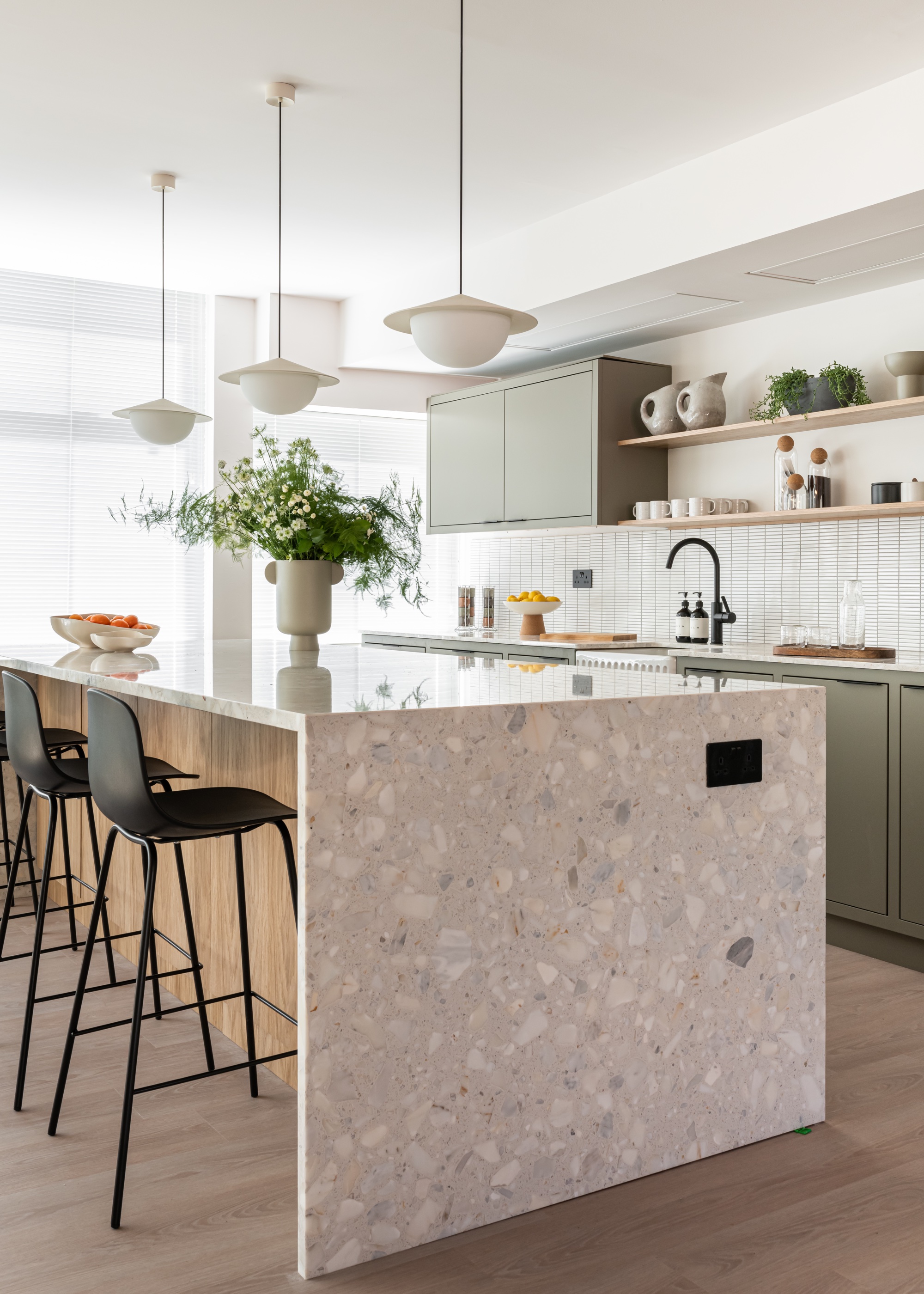 white kitchen with green kitchen cabinets, open shelving and large kitchen island