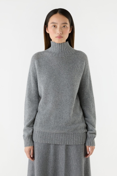 a model wearing a grey cashmere jumper from bamford
