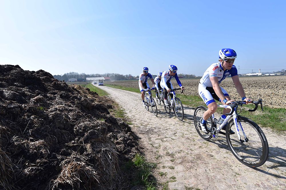 UnitedHealthcare passes by what used to cover up the cobbles: mountains of mud