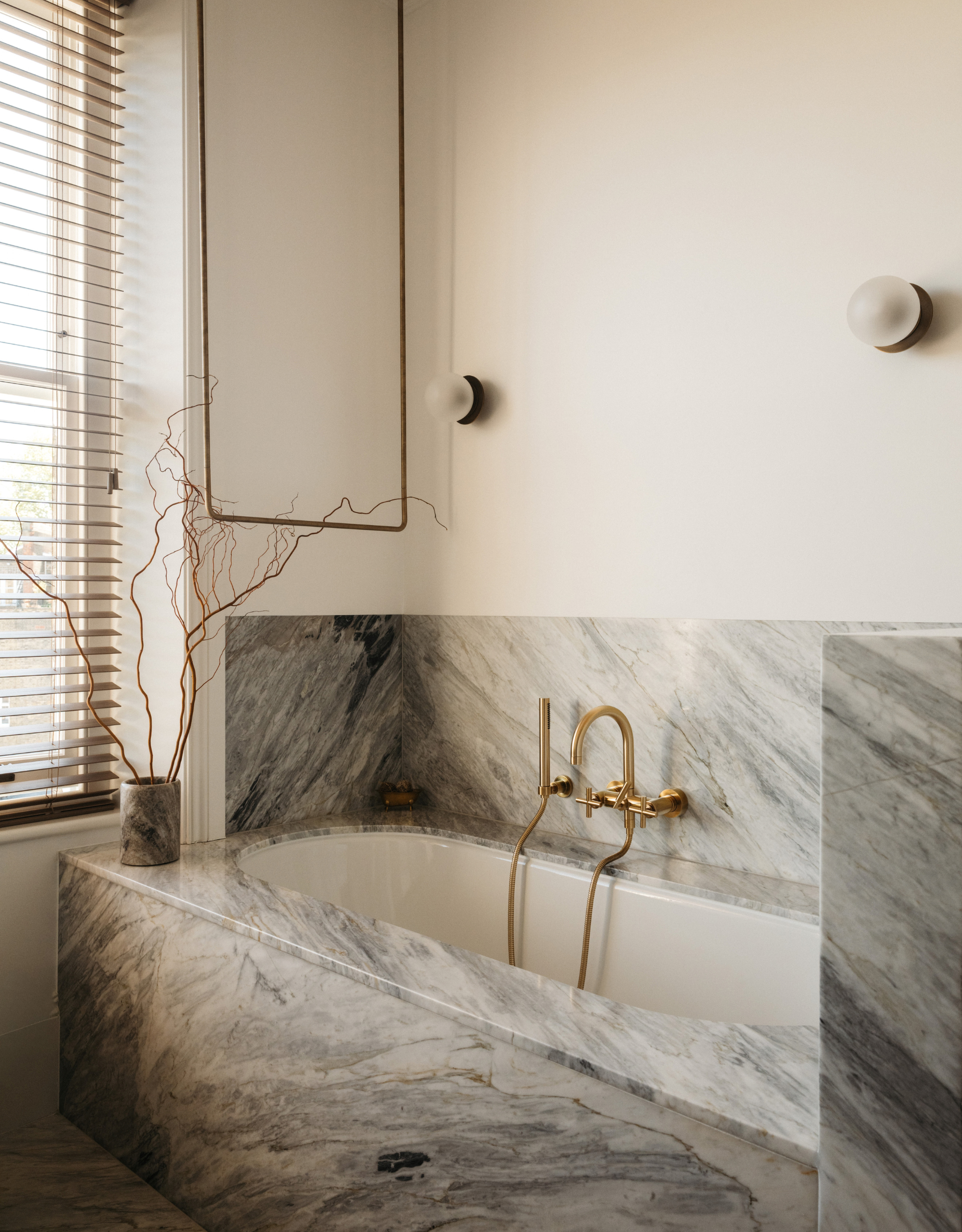 beautiful modern bathroom, with built-in marble tub and bronze hardware