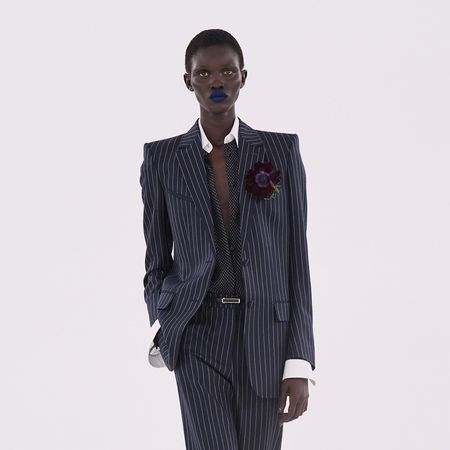 Tom Ford models walking on the runway wearing PVC, a tailored pinstripe suit, and denim 
