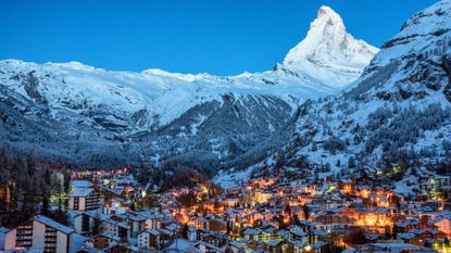 Illuminated buildings in the village under the Matterhorn at dusk