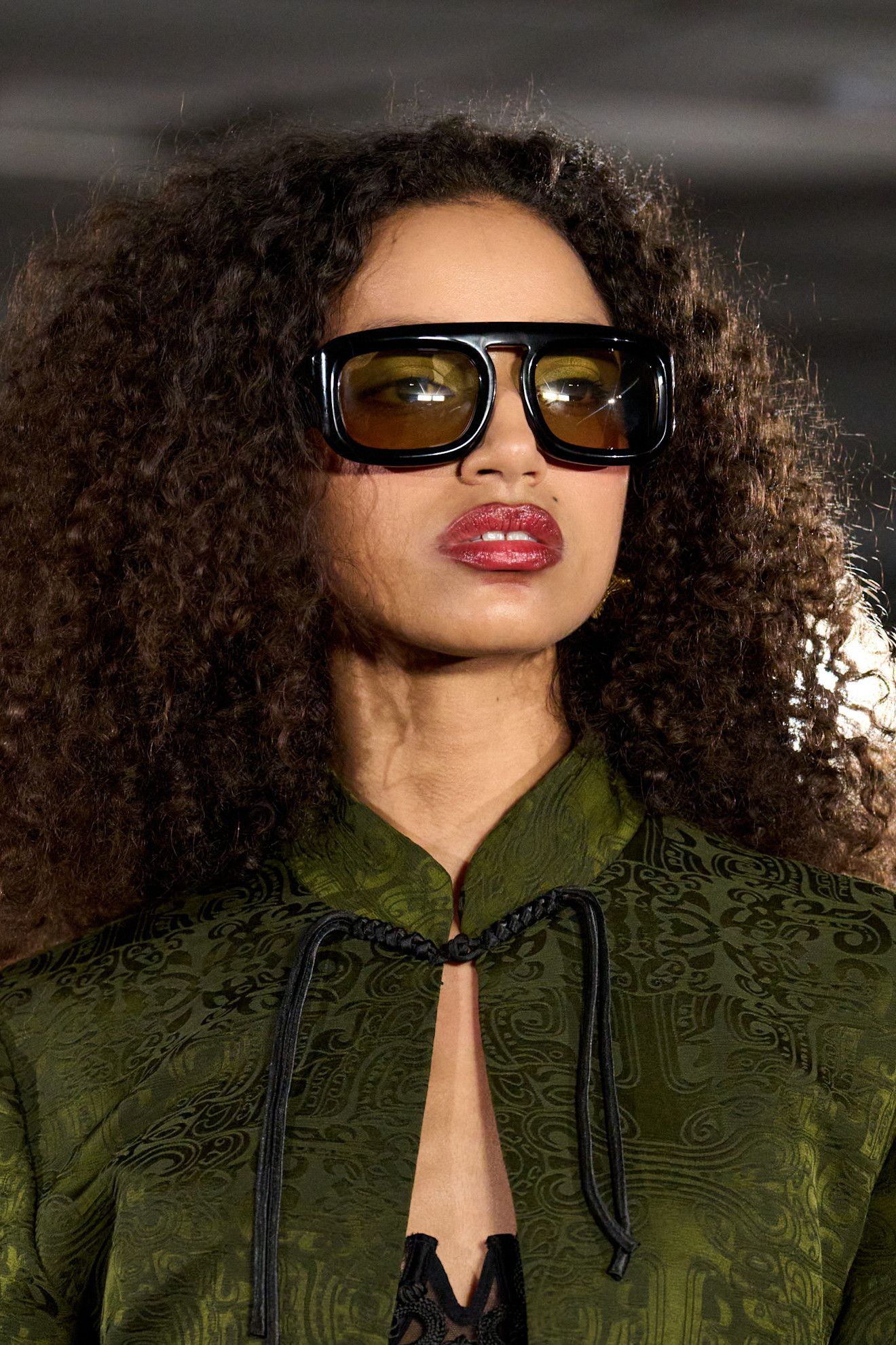 Kim Shui clp F26 011, a woman with brown curls in sunglasses with red lips