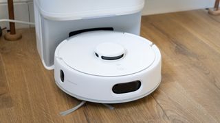 SwitchBot K10+ Pro mini robot vacuum in its dock