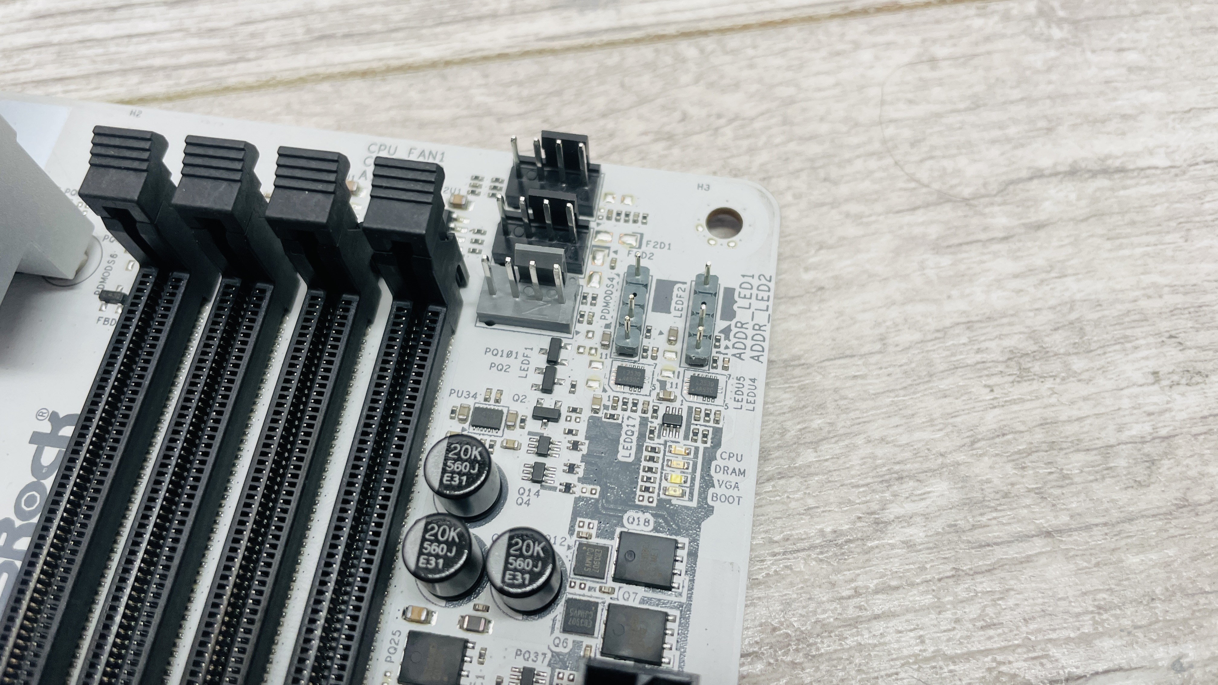 An ASRock B860 Steel Legend Wi-Fi motherboard on a desk with SSD covers removed.