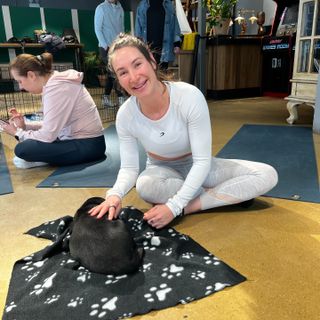 Sam stroking puppy during yoga class