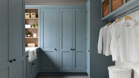 pale blue Shaker utility room with full height units and hanging space for washing