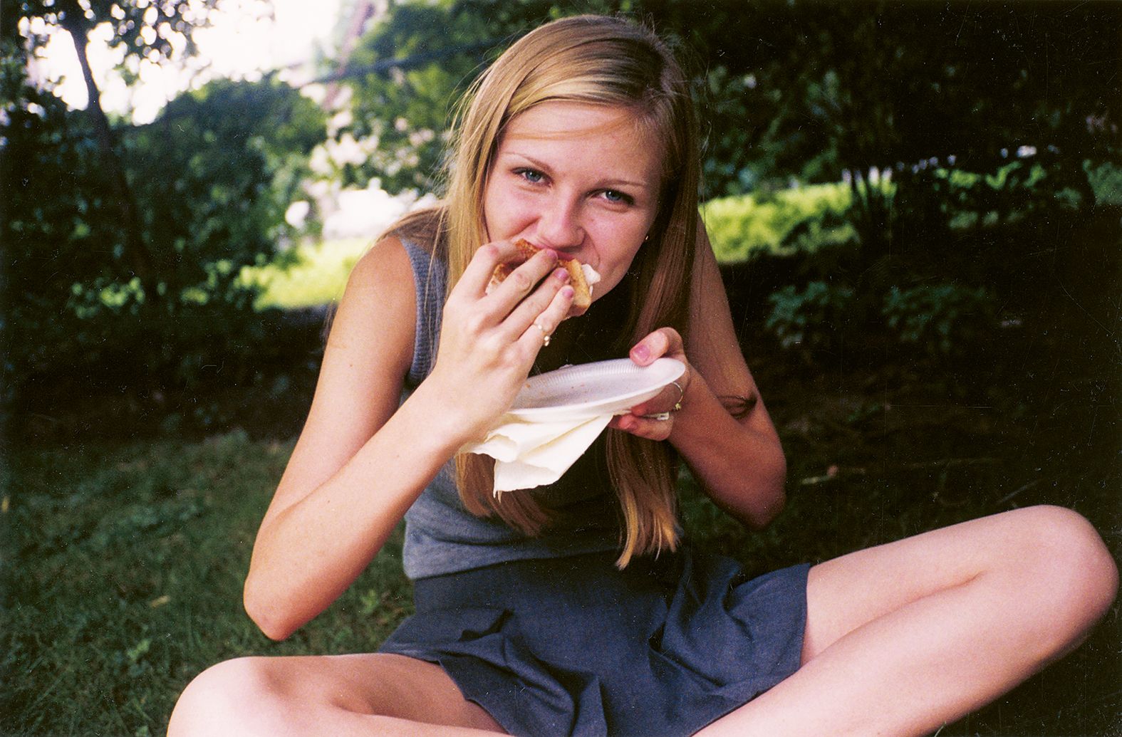 Actor Kirsten Dunst eating a sandwich between takes, on the set of The Virgin Suicides