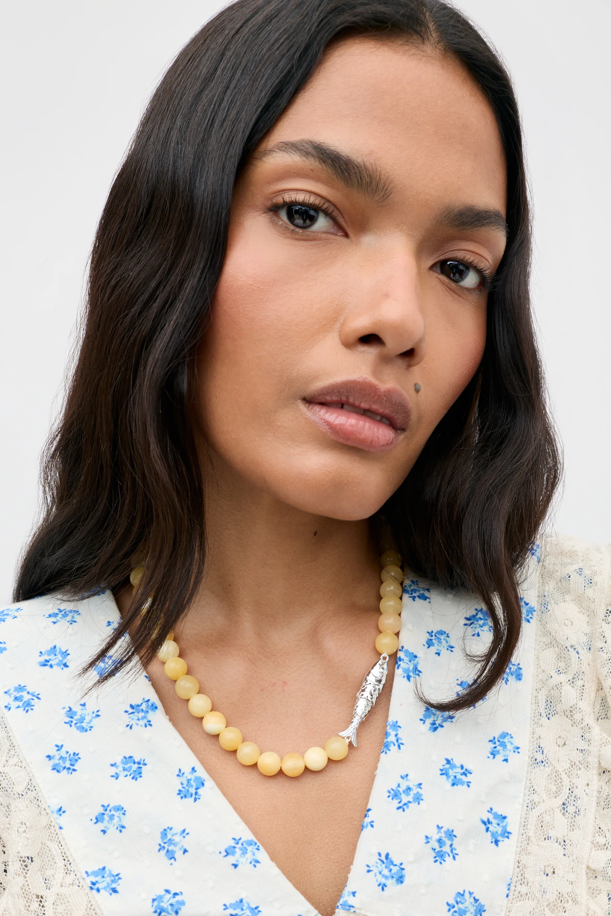 A model wears a chunky beaded necklace.