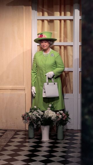 Flowers have been laid in front of the wax statue of late Britain's Queen Elizabeth II at the Grevin wax museum in Paris on September 9, 2022, a day after the death of the monarch. - Queen Elizabeth II, the longest-serving monarch in British history, died at her Scottish Highland retreat on September 8 at the age of 96.