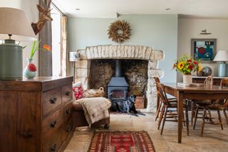 dining room with wood burning stove in fireplace