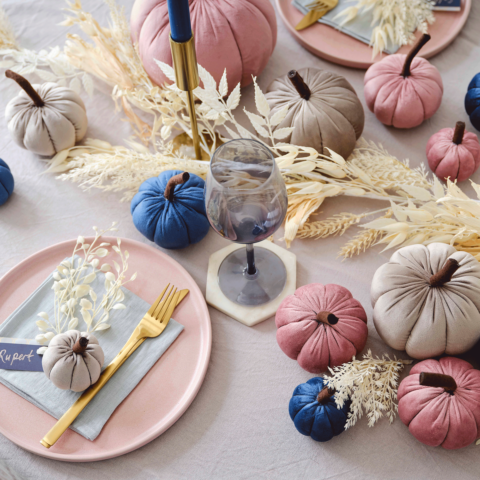 Pink and blue plush pumpkins on table