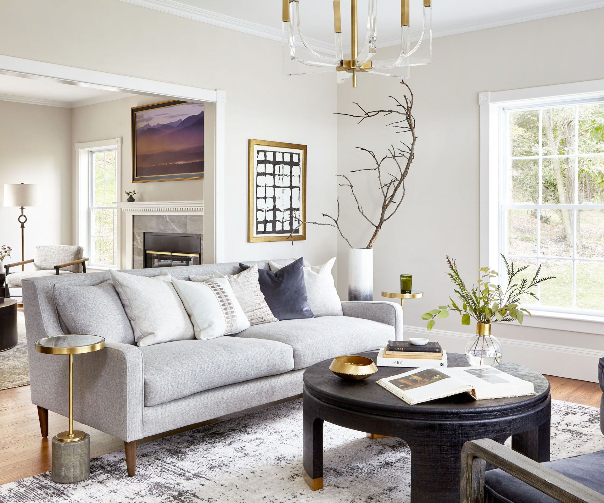 Neutral living room with grey sofa, dark wood coffee table and gold details