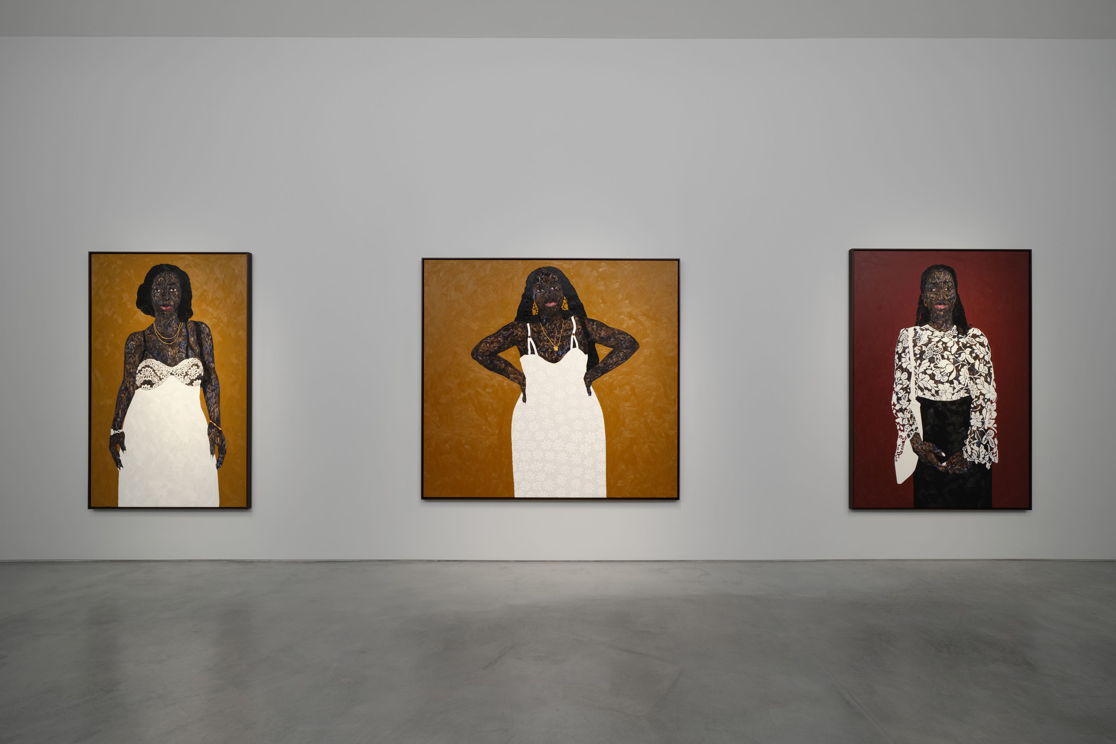 View of an art gallery installation with dark wood walls and multiple expressive portrait paintings. In the foreground, a large black metal structure with vertical bars frames additional paintings inside, while more portraits hang on the walls in the background.