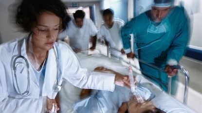 A team of hospital workers rush to help a patient.