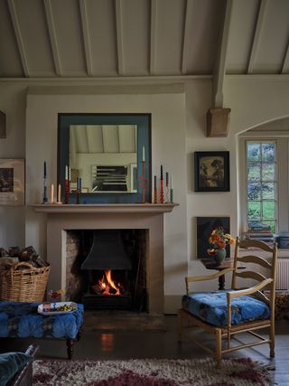 A living room with a mantel decorated with candles