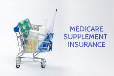 Full of medicines little shopping cart and the inscription Medicare supplement insurance