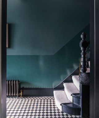 entryway with teal wall, matt paint top half and gloss paint lower, black and white checkered floor tiles