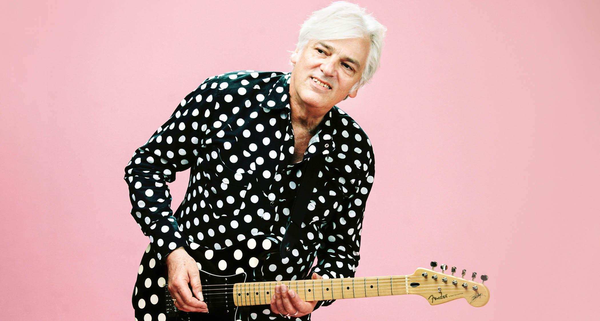 Robyn Hitchcock plays a polka-dot Strat against a pink background &mdash; and wears a matching polka-dot shirt