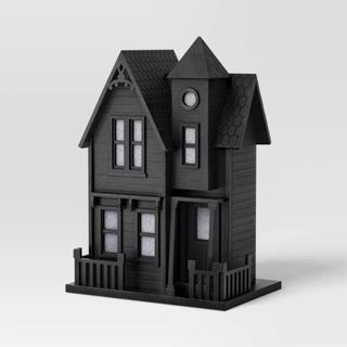 Large Haunted House Figurine against a gray background.