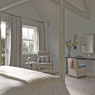luxurious guest bedroom with exposed whitewashed beams