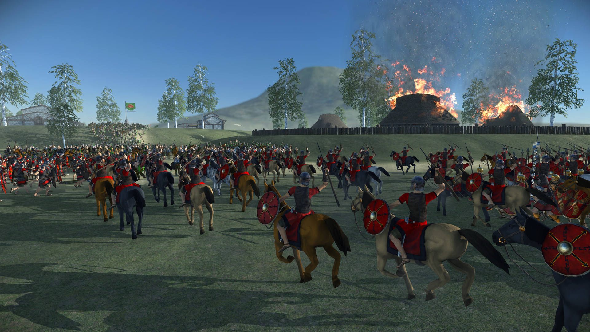 Roman soldiers riding horses after burning down a settlement during one of the best Total War games, Total War: Rome